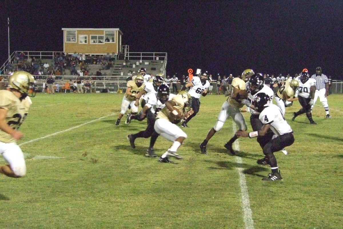 Image: Offense — The offensive line plunges ahead.