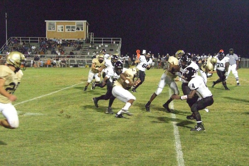 Image: Offense — The offensive line plunges ahead.