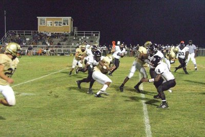 Image: Offense — The offensive line plunges ahead.