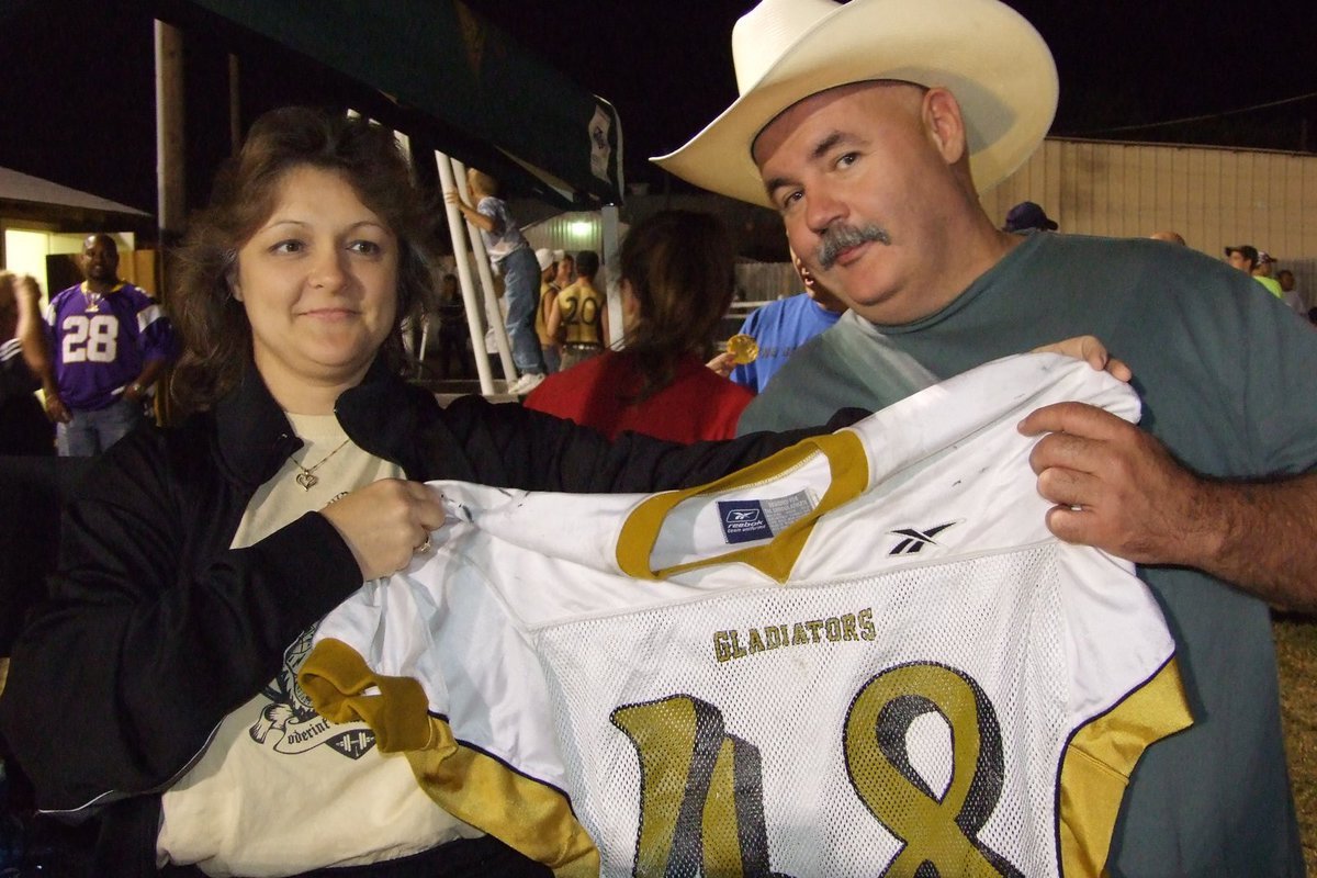 Image: Vintage jersey award — Flossie Gowin awards Donald Brummett  the vintage jersey from the Italy Athletic Booster Club.