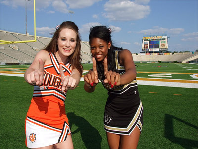 Image: FCA Red Team’s cheerleaders, Paige Dickerson of Aquilla, and Kiona Johnson of Hubbard, show their support for Jasenio Anderson(11) by displaying his jersey number before the Victory Bowl kickoff.