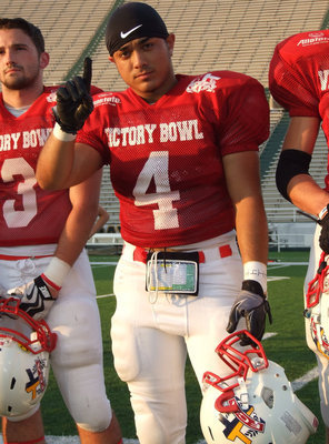 Image: Milford’s Rolando Vega(4) is recognized at halftime of the 2011 FCA Victory Bowl and expresses confidence in his Red Team’s 27-0 halftime lead. 