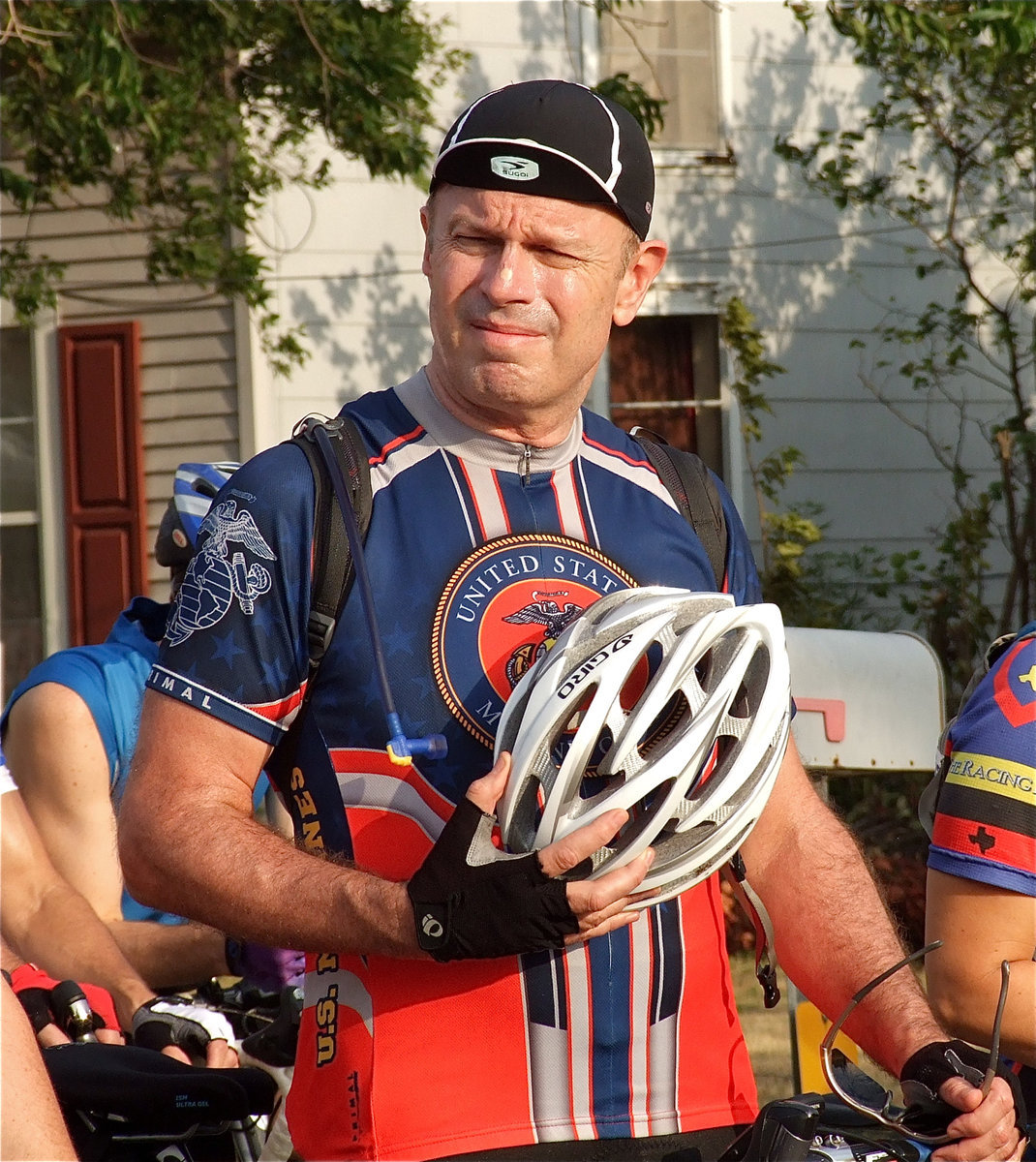 Image: This cyclist pays tribute during the singing of the National Anthem.