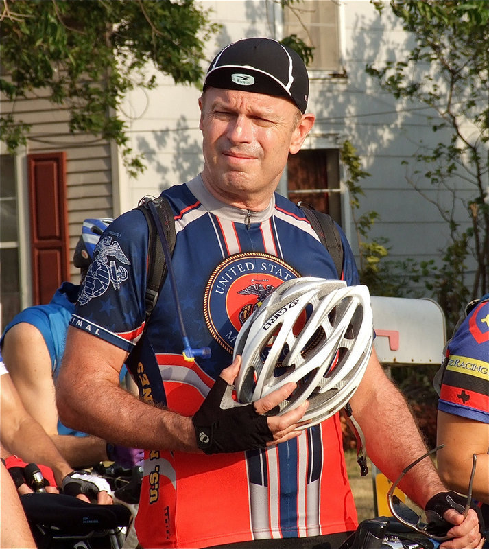 Image: This cyclist pays tribute during the singing of the National Anthem.