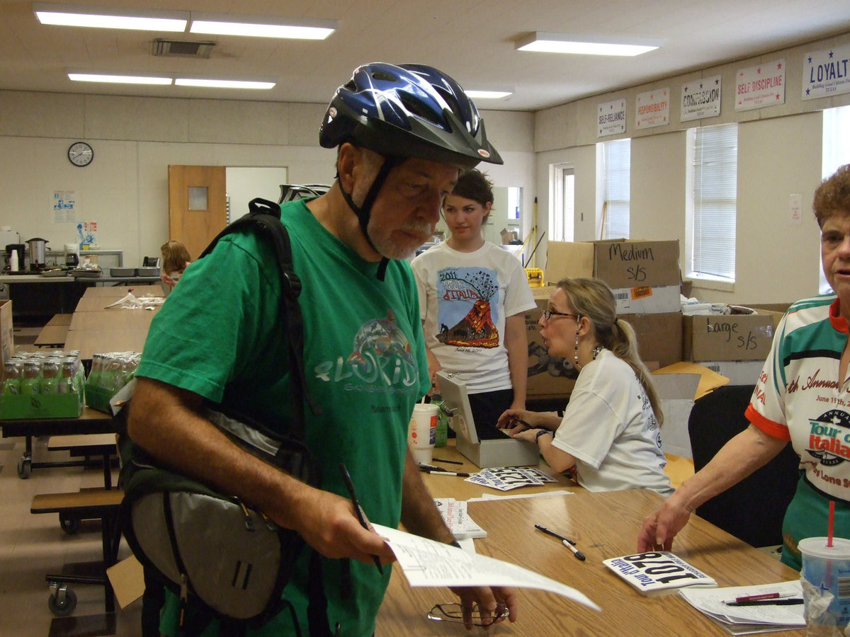 Image: Local dentist, Dr. George Telatnyk, registers his two sons and himself for the ride.