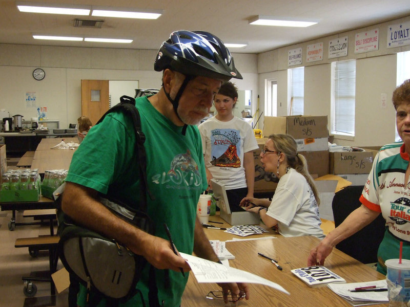 Image: Local dentist, Dr. George Telatnyk, registers his two sons and himself for the ride.
