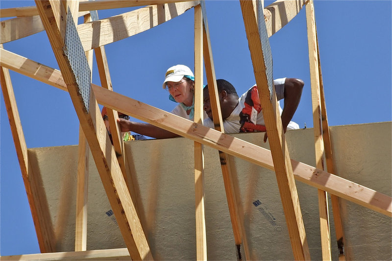 Image: Edwin Wallace, a member of the Mt. Gilead Baptist Church, helps with the roofing of the new church.