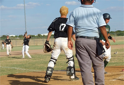 Image: Catcher Brandon Souder(17) and third baseman Reece Marshall(3) look on as pitcher Kyle Jackson(2) catches a pop-up for out number three.