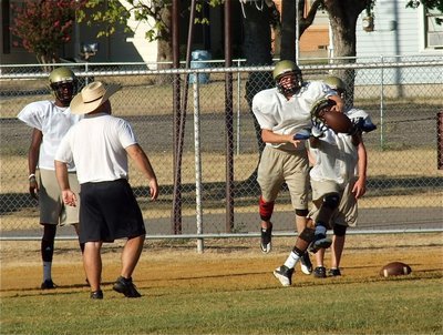 Image: Head coach Craig Bales tosses a ball up for grabs.