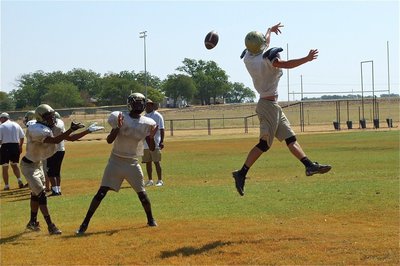 Image: Jase Holden deflects a pass intended for Trevon Robertson.