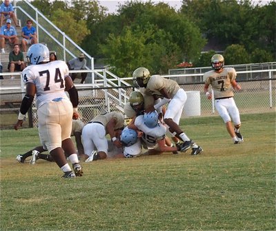 Image: Gladiators Ryheem Walker, Omar Estrada, Ethan Saxon and Devonta Simmons try to hold back the Cougars.