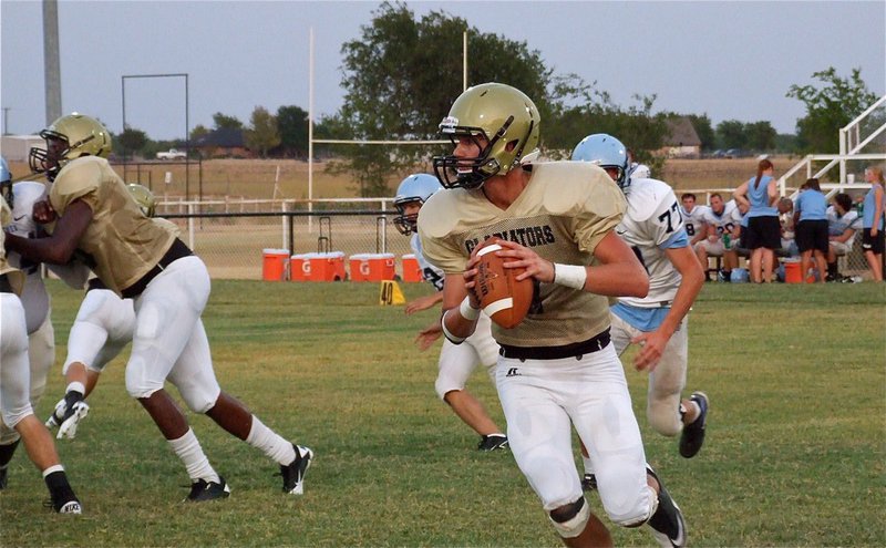 Image: Looking to pass, Jase Holden(7) looks for a receiver downfield.