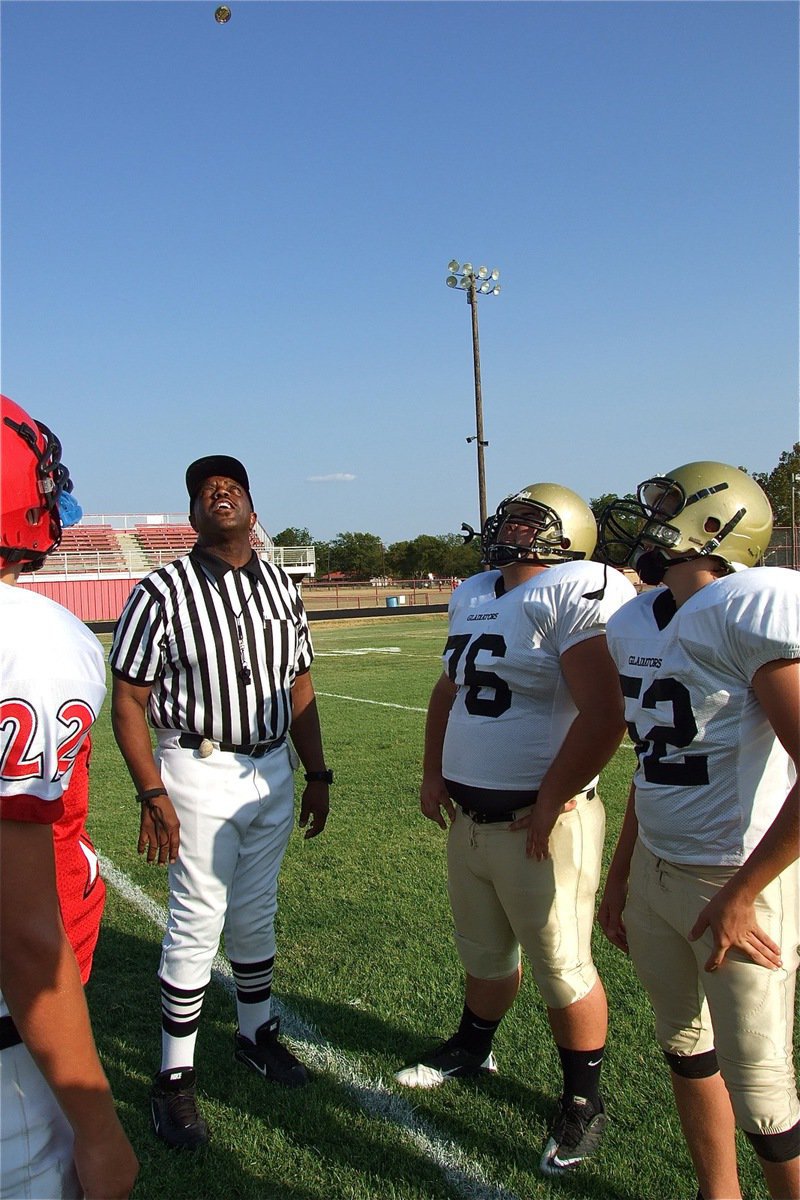 Image: Game captains for Italy’s JV Gladiators, Hank Seabolt(76) and Bailey Walton(52), watch the coin toss before their team’s game against Maypearl. 