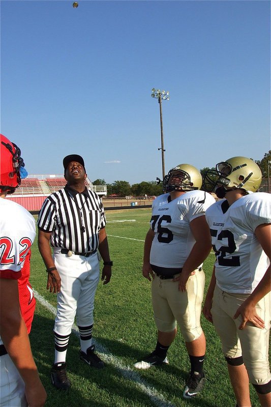 Image: Game captains for Italy’s JV Gladiators, Hank Seabolt(76) and Bailey Walton(52), watch the coin toss before their team’s game against Maypearl. 