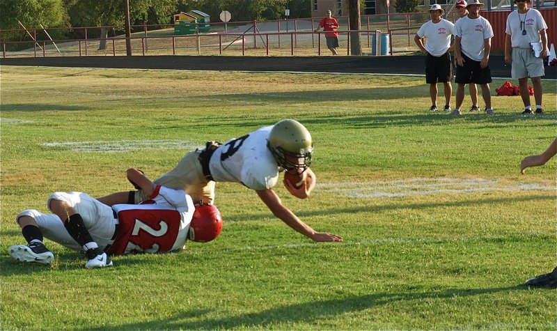 Image: Italy’s JV quarterback, Justin Wood(48), dives toward the goal line.