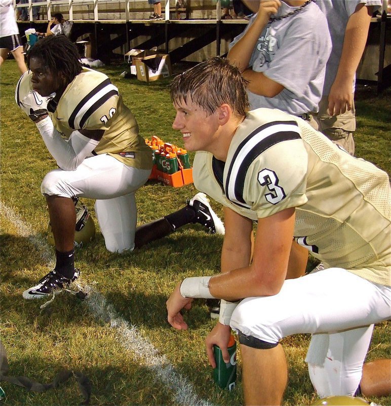 Image: Ryheem Walker(10) and Jase Holden(3) take a well deserved break late in the game and begin soaking in their 30-0 shutout victory over Maypearl.