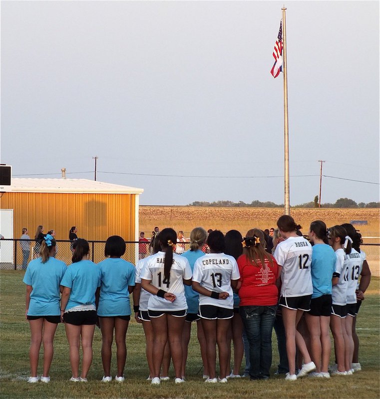 Image: The Italy High School and JV/Junior High Cheerleaders sing the National Anthem before the game between Italy and Maypearl.
