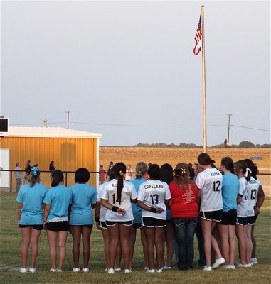 Image: The Italy High School and JV/Junior High Cheerleaders sing the National Anthem before the game between Italy and Maypearl.