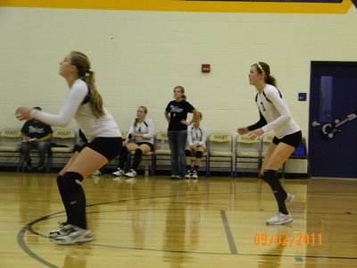 Image: Madison Washington (freshman) and Kaitlyn Rossa (senior) react to the ball.