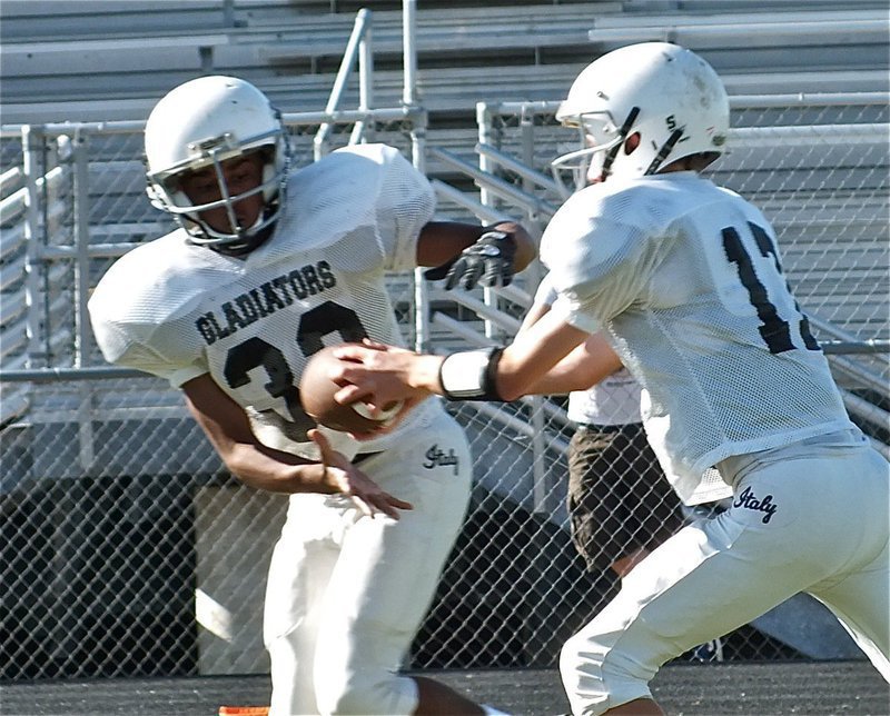 Image: Brandon Connor(17) hands off to Jaray Anderson(32).