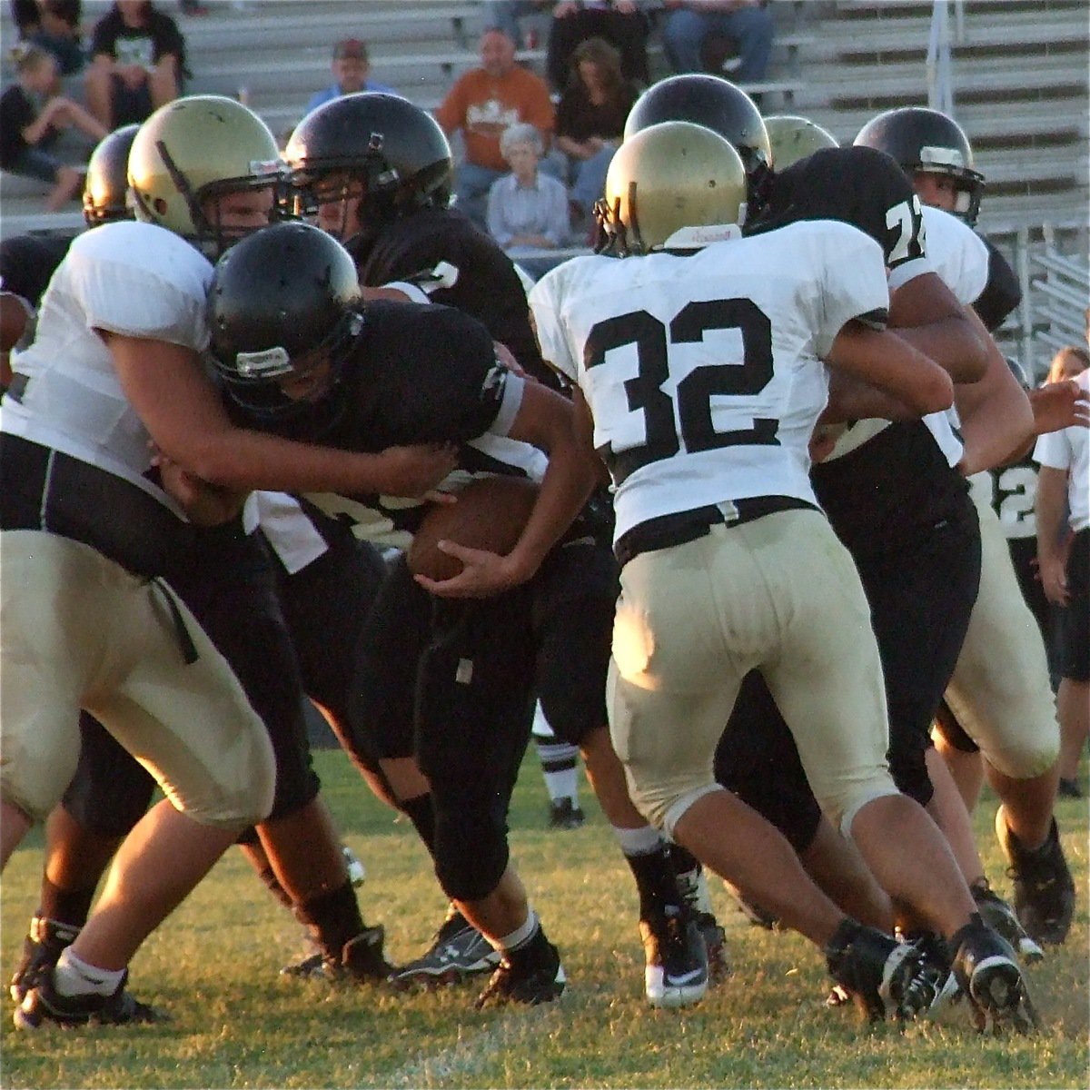 Image: Defensive tackle Colin Newman(76) gets hold of a Palmer Bulldog with teammate Cody Medrano(32) on his way to help.