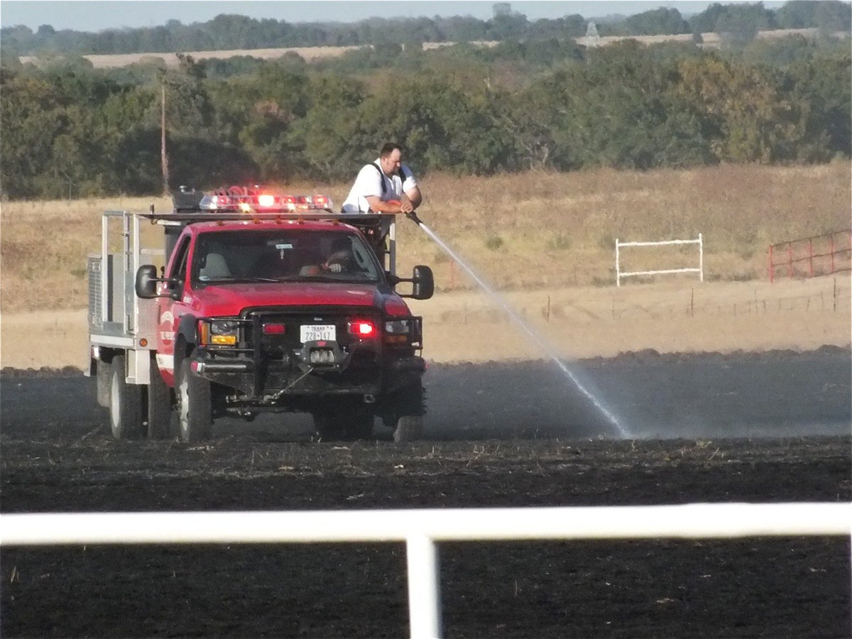 Image: Forreston firefighters keep the potential danger watered down.