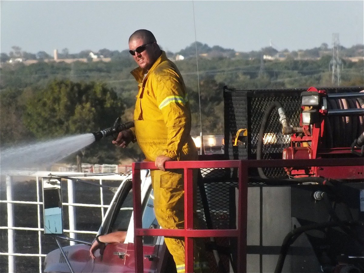 Image: One last pass along the road’s edge gives the Forreston, Milford and Italy Volunteer Fire Departments another victory.