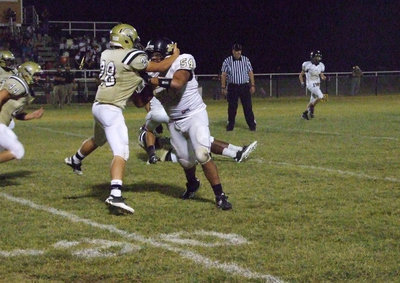 Image: Italy’s Kyle Jackson(28) attempts to throw a Palmer blocker out of his way.