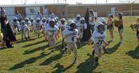 Image: Lane Shifflett(26) and Willie Talton(4) lead the way as the IYAA C-Team Gladiators (K-2nd) charge onto Willis Field in Italy to take on the Rice Bulldogs to kickoff the 2011 season.