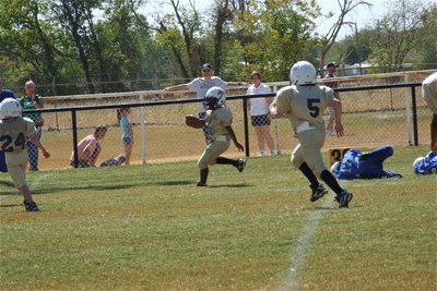 Image: Ricky Pendleton(21) gets loose in Rice’s secondary while teammates Gage Wafer(24) and Erik Martinez(5) look for Bulldogs to block downfield.