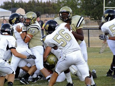 Image: Gladiators Kyle Jackson(28) and Larry Mayberry, Jr.(77) try to get tailback Ryheem Walker(10) an extra yard.