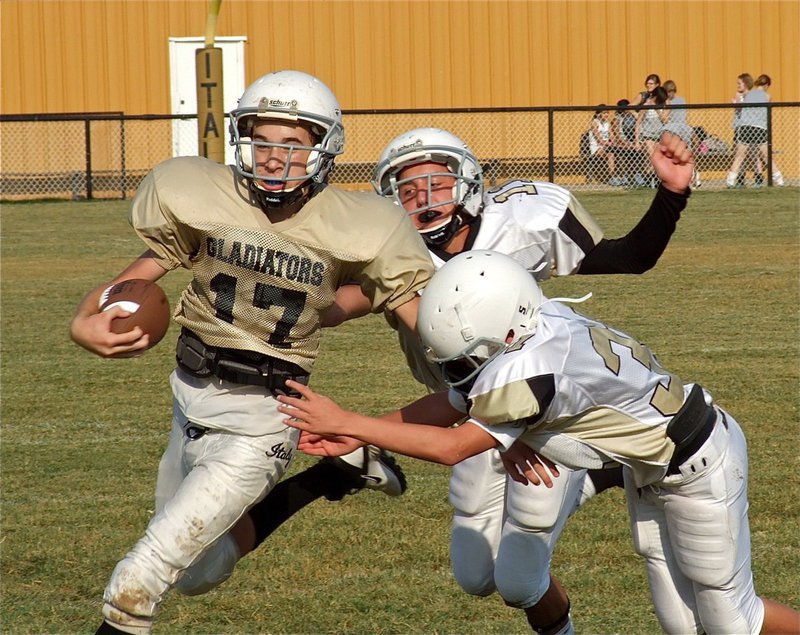 Image: As quarterback for the Italy Jr. High Gladiators on Thursday, Ryan Connor(17) kept Italy moving the ball consistently and helped the offense put up two touchdowns. The Hubbard Jaguars were impressive, as well, and pulled away in the second half to win 28-14.