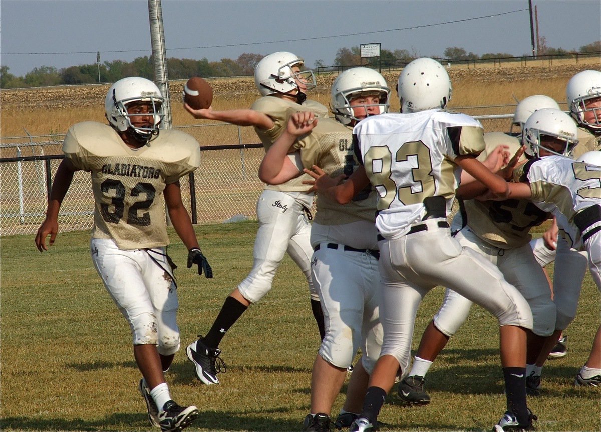 Image: Ryan Connor(17) throws behind a wall of protection proveided by Aaron Pittmon(50), Kenneth Norwood, Jr.(57) and cousin Brandon Connor(77) at center.