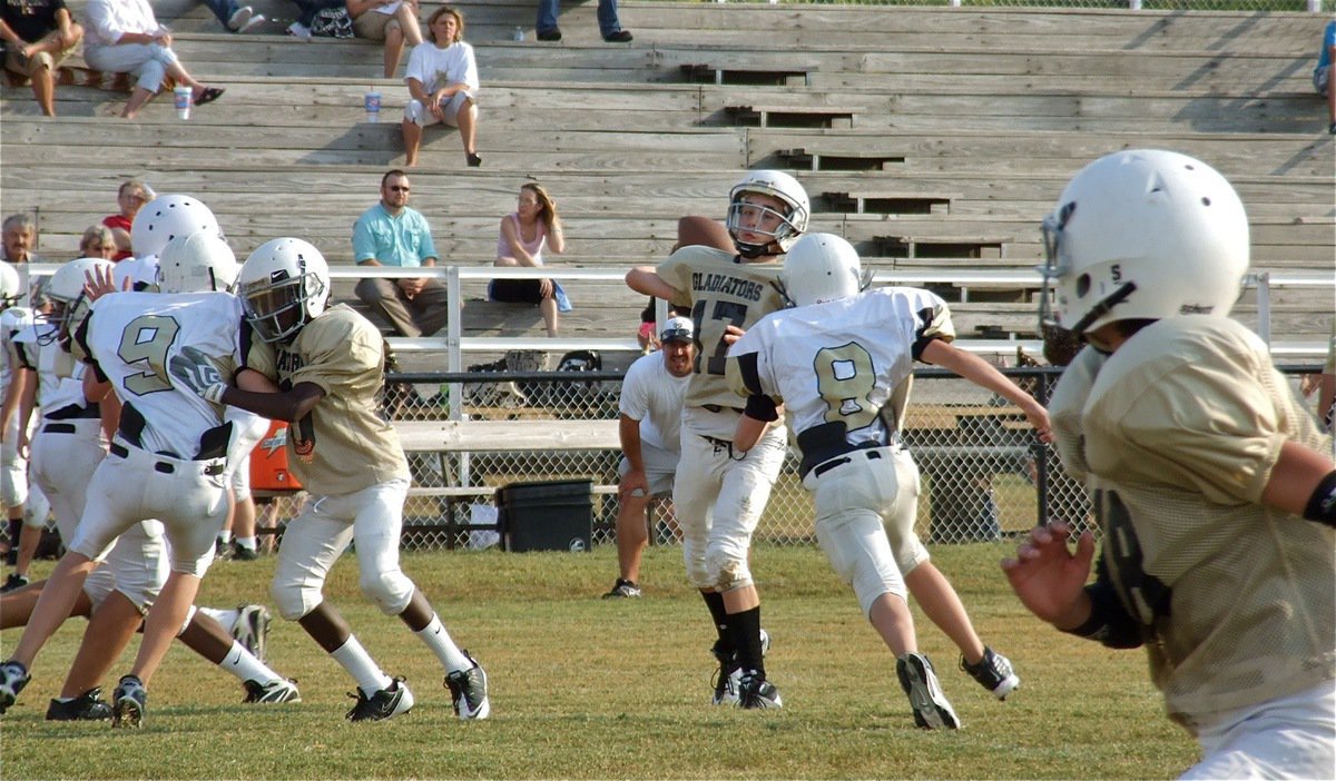 Image: Under pressure, Ryan Connor(17) launches a pass downfield intended for Mason Womack(88).