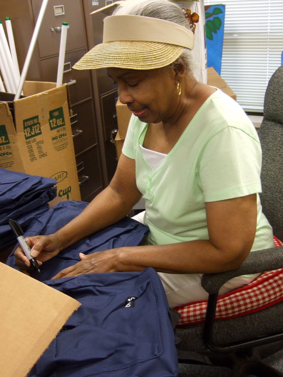 Image: Ruth Tarrant is putting the numbers on the backpacks.
