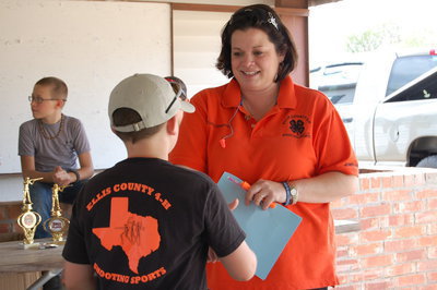 Image: Club Manager and Coach Shannon Edwards of Red Oak presents the champion buckle to Hunter Hinz.