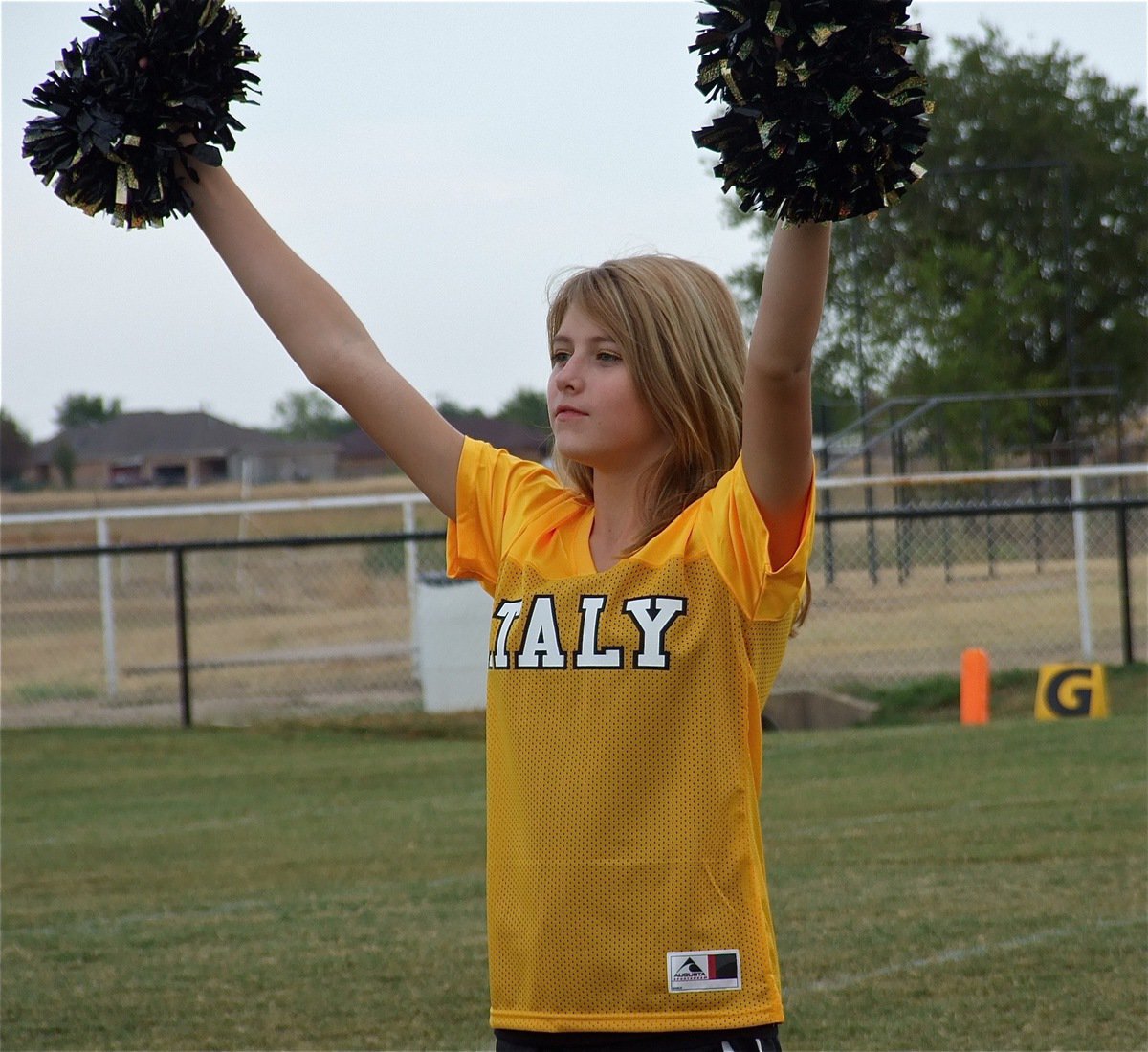 Image: Italy Jr. High Cheerleader Halee Turner Welcomes the Gladiators onto Willis Field.