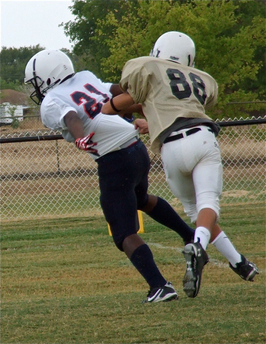 Image: Mason Womack(22) tries to “whoa” down Red Oak Life Mustang fullback, Brandon Gibson. A 7th grader, Gibson is the son of Tisa Clemons who is an IHS alumni (’89).