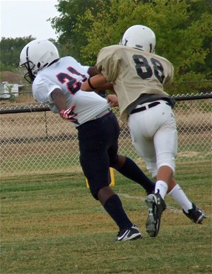 Image: Mason Womack(22) tries to “whoa” down Red Oak Life Mustang fullback, Brandon Gibson. A 7th grader, Gibson is the son of Tisa Clemons who is an IHS alumni (’89).