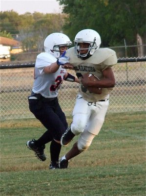 Image: Jaray Anderson(32) avoids a Mustang tackler.