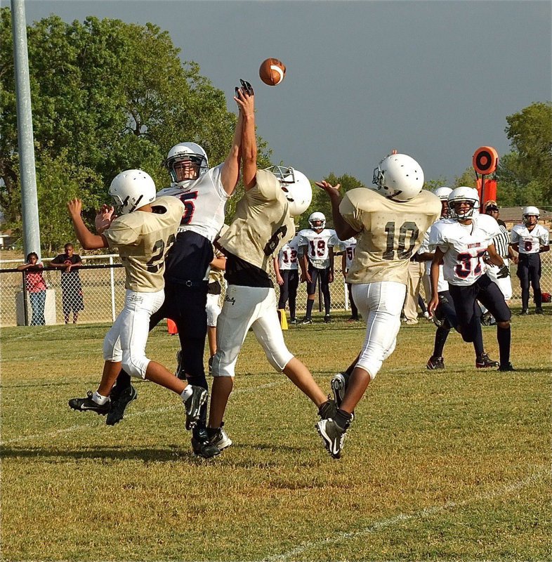 Image: Fabian Cortez(22) and Joe Celis(6) disrupt a Mustang pass attempt allowing Cameron Carter(10) to make the interception.