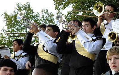 Image: The Gladiator Regiment Marching Band and Flag Corp blare the beat of champions from the bleachers.