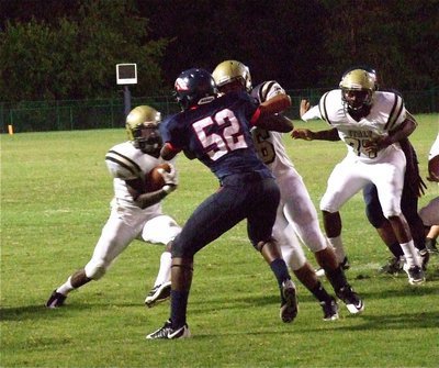 Image: Senior offensive lineman, Omar Estrada(56) and Larry Mayberry, Jr.(77), provide a cutback lane for Ryheem Walker(10) who takes full advantage on his way to a first half touchdown.
