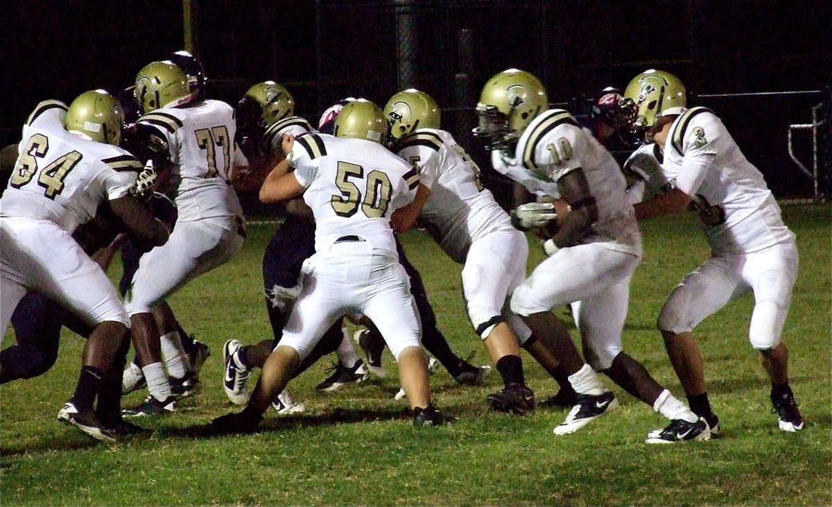Image: Gladiator offensive lineman Adrian Reed(64), Larry Mayberry, Jr.(77), Zain Byers(50) and Kelton Bales(75) fence in the Mustang defense allowing Ryheem Walker(10) to take the handoff from Jase Holden(3) and run in for another Italy touchdown.