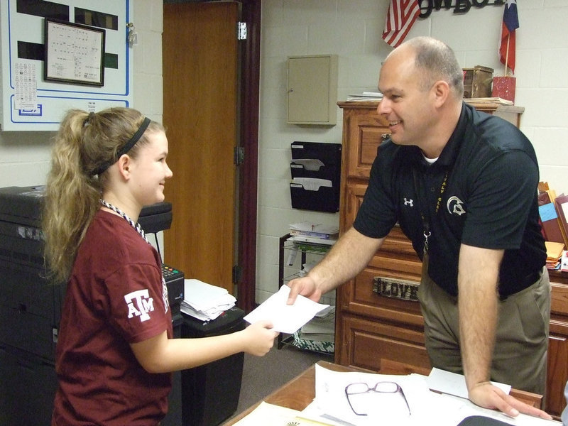 Image: Mr. Joffre puts the students in the focus. Tara Wallis is giving the new principal a reason to smile.
