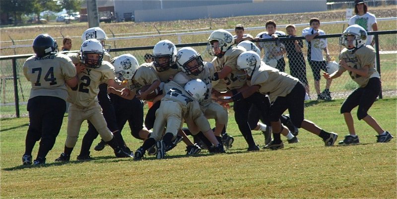Image: IYAA B-team defenders Brennon Sigler(82), Eric Martinez, Preston Rasco(9) and Ty Cash(24) converge on a Bulldog back.