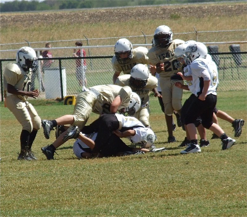 Image: Isaac Salcido(80) delivers the final knockout as the IYAA A-team defeats Palmer 32-0.