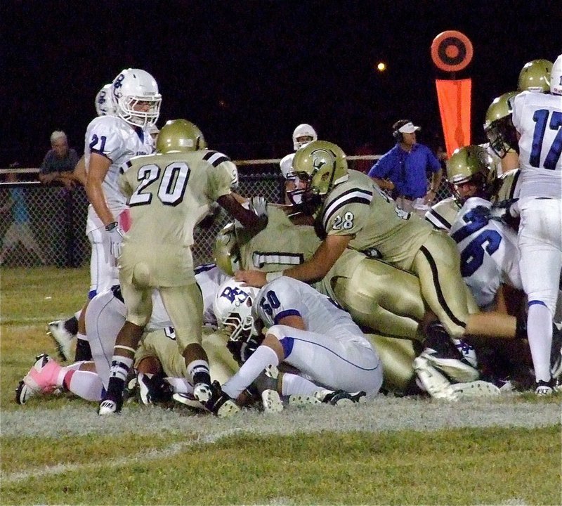 Image: Ethan Saxon(44), Jamal Lewis(11), Kyle Jackson(28) and Trevon Robertson(20) are the identified Gladiators holding Blooming Grove to a limited gain.