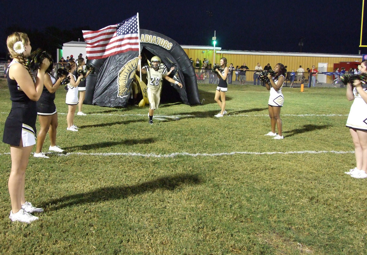 Image: Kyle Jackson(28) holds the flag proudly as he emerges from the Italy Gladiator tunnel.