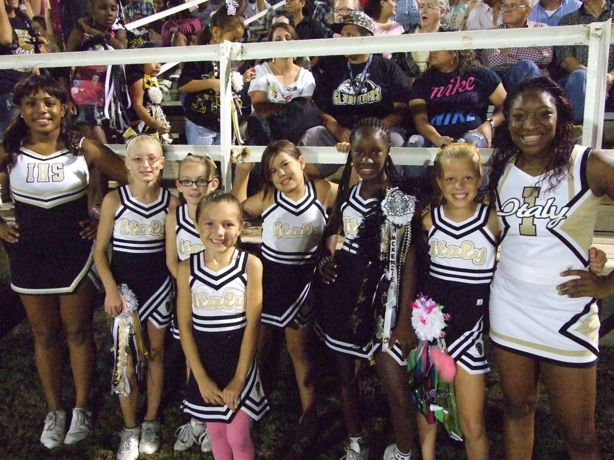 Image: Third and Fourth grade IYAA cheerleaders cheer with the varsity cheerleaders at Homecoming.